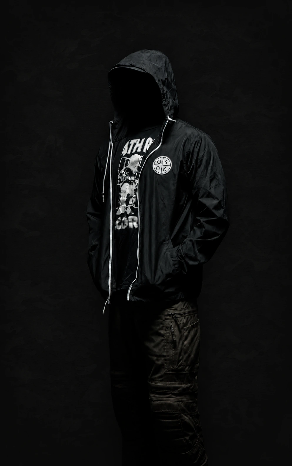 Hooded model wearing an OSOK windbreaker